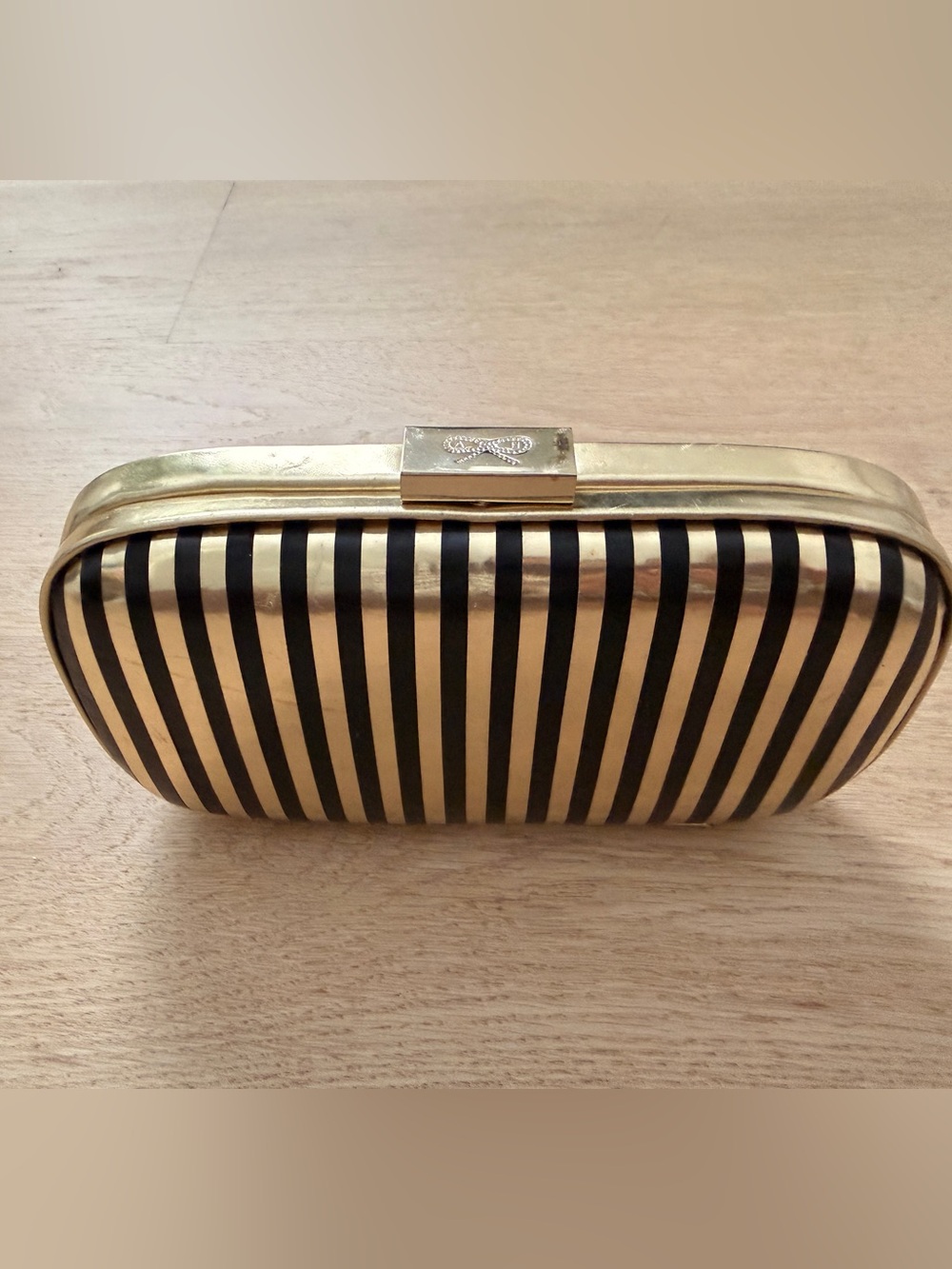 Anya Hindmarch Black and Gold Striped Hard Shell Clutch